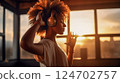 Dancing african american hipster girl wearing wireless headphones on the background of window and sunset in apartment. AI Generated 124702757