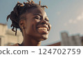headshot african-American happy woman smiling. Street portrait of strong, confident woman in city at sunset. Golden Hour. Relationship with yourself. Generated by AI 124702759