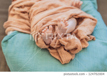 Newborn baby comfortably resting in a cozy baby nest. Safe and peaceful sleep concept for infants Newborn baby comfortably resting in a cozy baby nest. Safe and peaceful sleep concept for infants 124702804