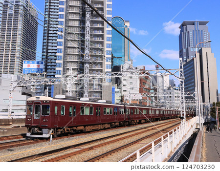 Hankyu 7000 series train on the Takarazuka Line running near Nakatsu Station Hankyu 7000 series train on the Takarazuka Line running near Nakatsu Station 124703230