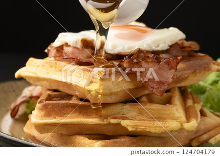 Waffles and bacon and eggs breakfast Waffles with honey Waffles and bacon and eggs breakfast Waffles with honey 124704179