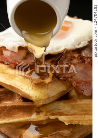 Waffles and bacon and eggs breakfast Waffles with honey 124704182