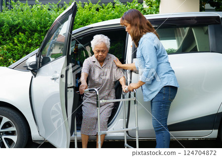 Caregiver help Asian elderly woman disability patient use walker to get in car. Caregiver help Asian elderly woman disability patient use walker to get in car. 124704872