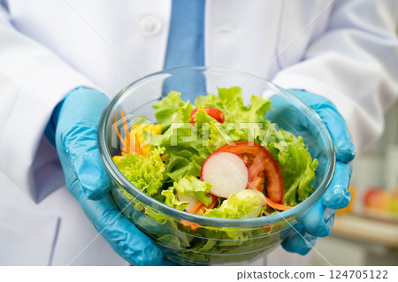 Asian Nutritionist holding healthy food for patient in hospital, nutrition and vitamin. Asian Nutritionist holding healthy food for patient in hospital, nutrition and vitamin. 124705122