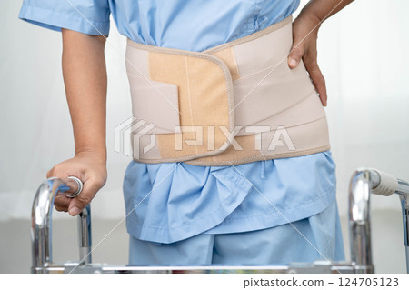Asian senior pain back wearing elastic support belt with walker. Asian senior pain back wearing elastic support belt with walker. 124705123