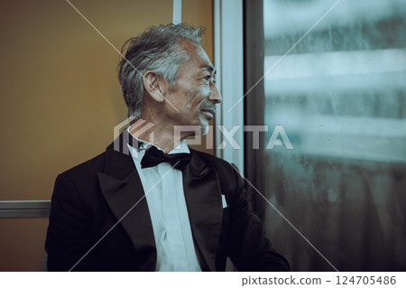 Senior man looking out the window on a train Senior man looking out the window on a train 124705486