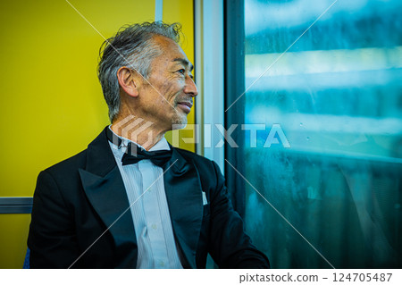 Senior man looking out the window on a train Senior man looking out the window on a train 124705487