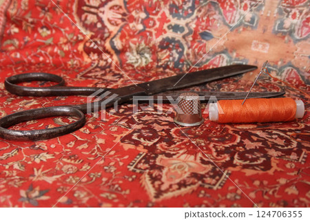 Orange Thread With Thimble on Colorful Vintage Fabric 124706355