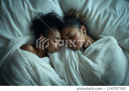 Close up of a young young loving female couple sweet sleeping embracing each other. A close-up of the couple sleeping, their loving embrace highlighting the intimacy they share in their dreams. Close up of a young young loving female couple sweet sleeping embracing each other. A close-up of the couple sleeping, their loving embrace highlighting the intimacy they share in their dreams. 124707392