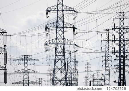 A high-voltage power transmission tower installed in an industrial area 124708326