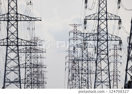 A high-voltage power transmission tower installed in an industrial area A high-voltage power transmission tower installed in an industrial area 124708327