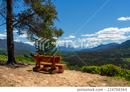 Scenic Wooden Bench Overlooking the Canadian Rockies. Summer mountain valley vista in Jasper National Park, Alberta, Canada. Cabin Lake Loop Trail. Scenic Wooden Bench Overlooking the Canadian Rockies. Summer mountain valley vista in Jasper National Park, Alberta, Canada. Cabin Lake Loop Trail. 124708364