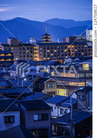 Night view of downtown Kyoto with mountain ranges and the illuminated five-story pagoda of Toji Temple Night view of downtown Kyoto with mountain ranges and the illuminated five-story pagoda of Toji Temple 124708617