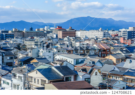 Kyoto city with mountain ranges and the five-story pagoda of Toji Temple in the distance Kyoto city with mountain ranges and the five-story pagoda of Toji Temple in the distance 124708621