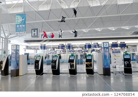 Check-in counters with baggage tag issuing machines 124708854