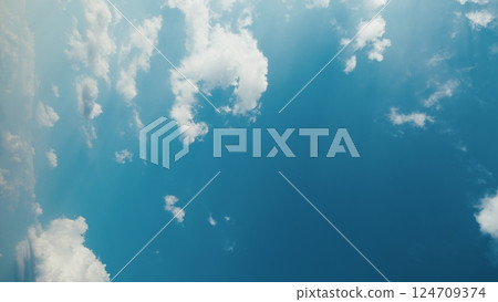 A Serene Blue Sky with Soft White Clouds Creates a Beautiful and Peaceful Ambiance 124709374
