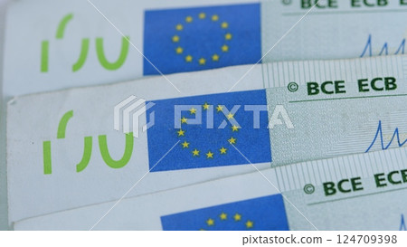 CloseUp of a Euro Banknote Featuring the Euro Symbol Alongside Stars Across Its Design 124709398