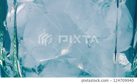 A Detailed CloseUp of Ice Cubes Nested in a Refreshing Glass, Perfectly Chilled for Enjoyment A Detailed CloseUp of Ice Cubes Nested in a Refreshing Glass, Perfectly Chilled for Enjoyment 124709940