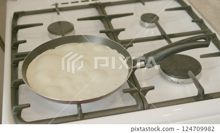 Fluffy Pancakes Cooking on Gas Stove in Nonstick Pan for a Delicious Breakfast or Brunch Fluffy Pancakes Cooking on Gas Stove in Nonstick Pan for a Delicious Breakfast or Brunch 124709982