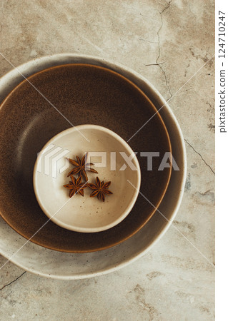 Bowls with aromatic star anise or badian on marble table, top view. Copy space Bowls with aromatic star anise or badian on marble table, top view. Copy space 124710247