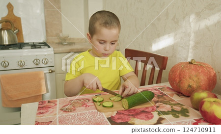 A child happily preparing a healthy snack in the warm, inviting kitchen environment 124710911