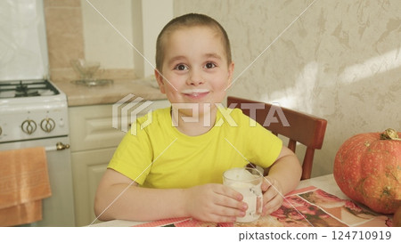 A Happy Child Enjoying a Delicious Treat in the Comfort of Their Home Environment 124710919