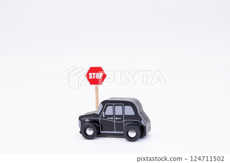 A black miniature car with a stop sign A black miniature car with a stop sign 124711502