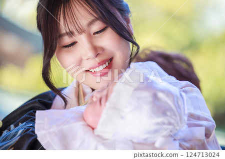 A mother gazing at her child at a shrine visit 124713024
