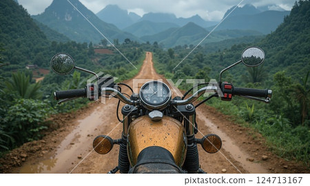 Adventure on dirt path through lush mountains - motorcycle touring journey Adventure on dirt path through lush mountains - motorcycle touring journey 124713167