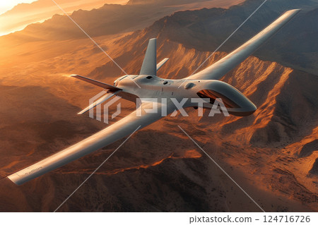 A drone soaring across the desert landscape at sunset, showcasing its aerodynamic design against the warm, colorful sky of the desert horizon. A drone soaring across the desert landscape at sunset, showcasing its aerodynamic design against the warm, colorful sky of the desert horizon. 124716726