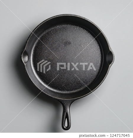 Rustic cast iron skillet on neutral background for culinary and kitchen design themes 124717045