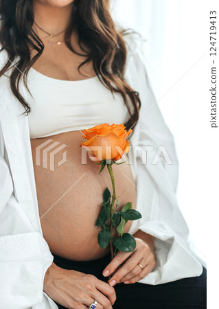 Beautiful pregnant woman at home in the doorway 124719413