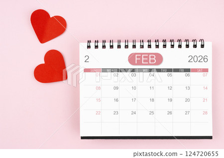 Red heart with February 2026 desk calendar on pink background. 124720655