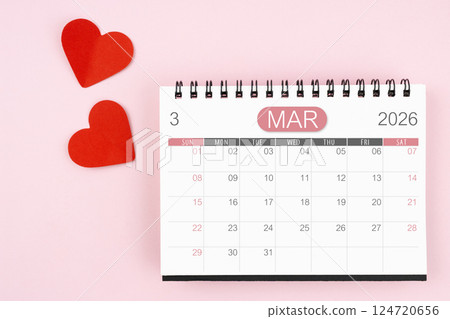 Red heart with March 2026 desk calendar on pink background. 124720656