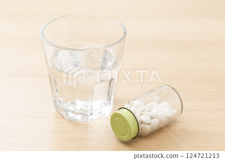 Medicines and drinking water on the desk Medicines and drinking water on the desk 124721213