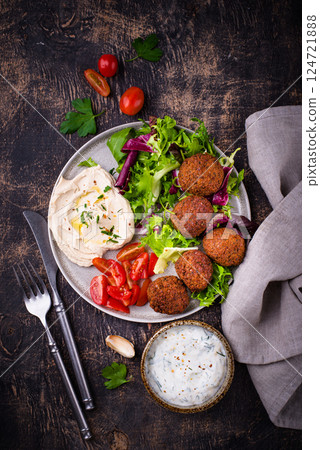 Salad with hummus, falafel and vegetables Salad with hummus, falafel and vegetables 124721888