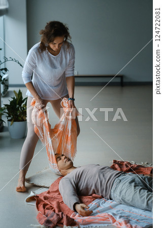 Healing session in a serene studio with a therapist assisting a patient in a laid-back atmosphere on a tranquil morning 124722081