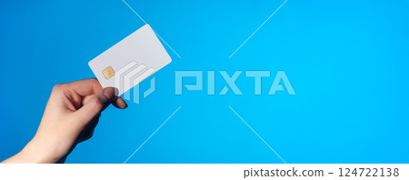 Card for payment. Hand holding blue plastic credit or debit card for finance, business, online 124722138
