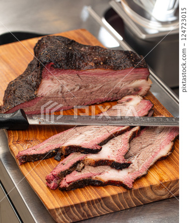 Sliced american beef brisket on a wooden board Sliced american beef brisket on a wooden board 124723015