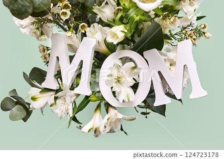 Happy mother's day. A beautiful floral arrangement with the word MOM Happy mother's day. A beautiful floral arrangement with the word MOM 124723178