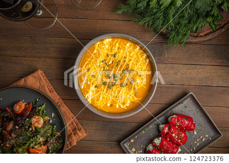 Portion of pumpkin cream soup with seeds 124723376