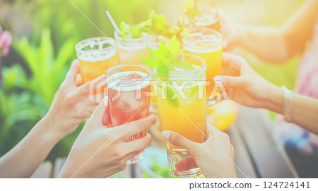 Friends toasting with colorful summer cocktails outdoors 124724141