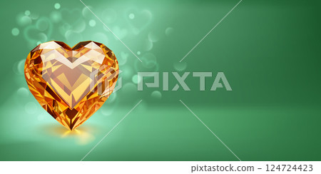 Sparkling yellow heart-shaped gemstone on green. 124724423