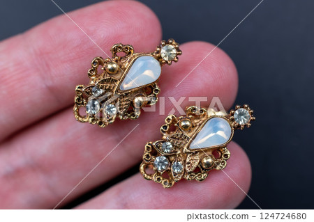 Unique earrings for women on a black background, promotional photo for an online vintage and handmade jewelry store 124724680