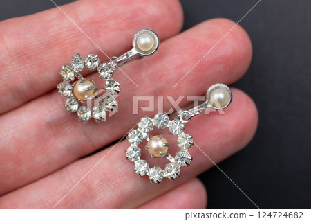 Unique earrings for women on a black background, promotional photo for an online vintage and handmade jewelry store 124724682