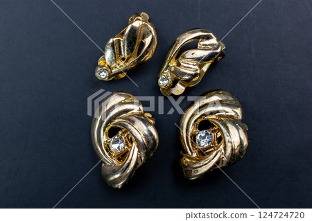 Unique earrings for women on a black background, promotional photo for an online vintage and handmade jewelry store 124724720