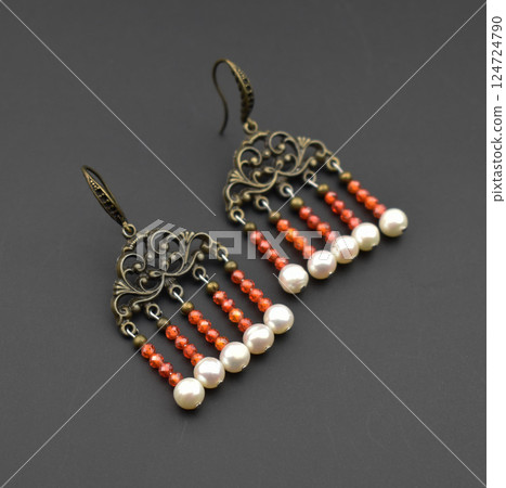 Unique earrings for women on a black background, promotional photo for an online vintage and handmade jewelry store 124724790