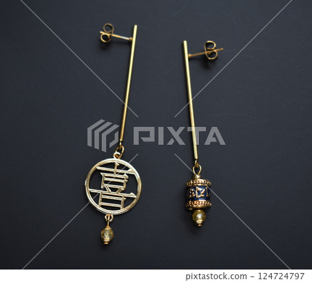 Unique earrings for women on a black background, promotional photo for an online vintage and handmade jewelry store 124724797