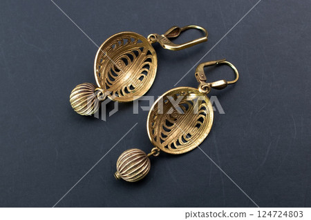 Unique earrings for women on a black background, promotional photo for an online vintage and handmade jewelry store Unique earrings for women on a black background, promotional photo for an online vintage and handmade jewelry store 124724803