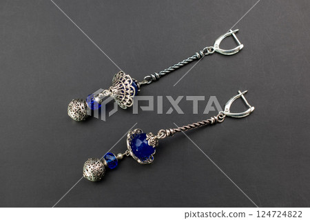 Unique earrings for women on a black background, promotional photo for an online vintage and handmade jewelry store 124724822